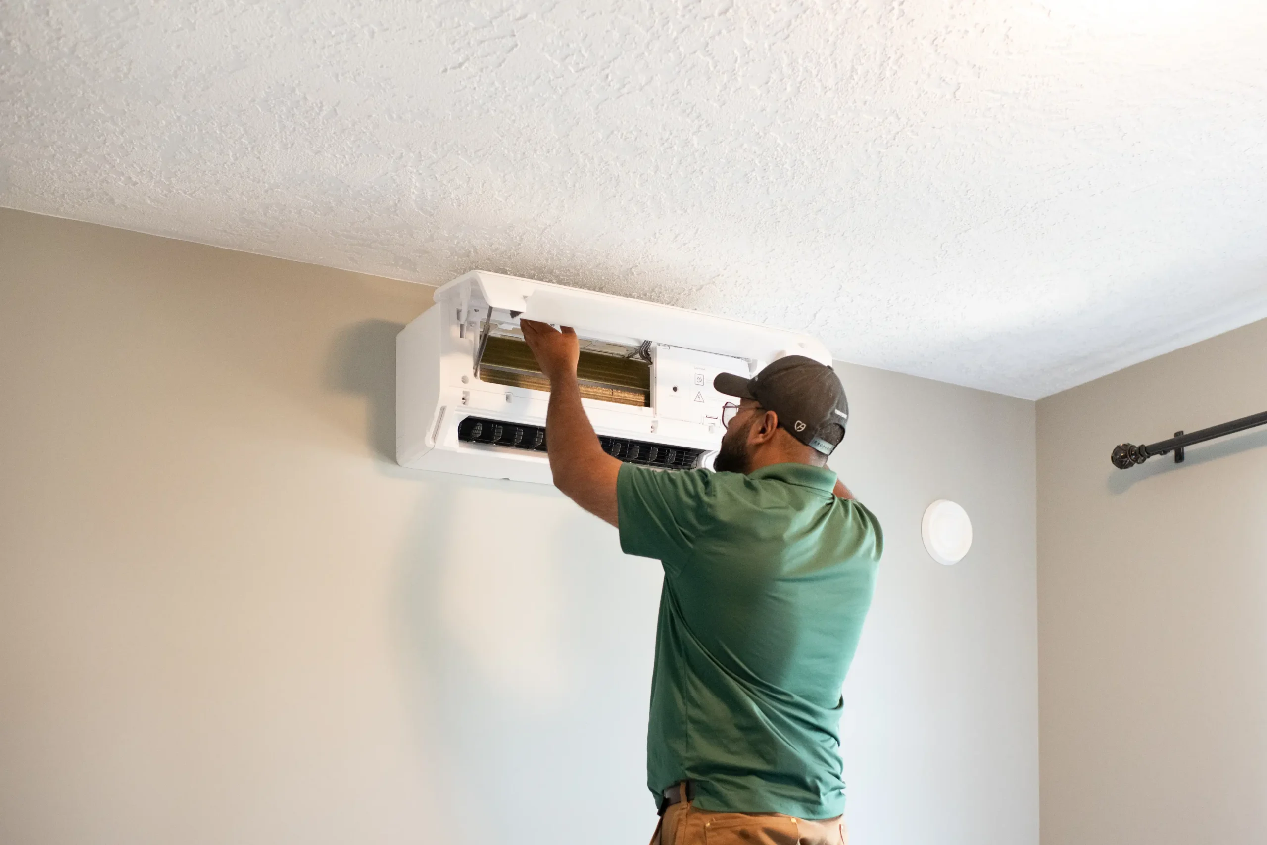 Sasquatch electrician wiring a Moovair heat pump on a Vancouver Island panel upgrade
