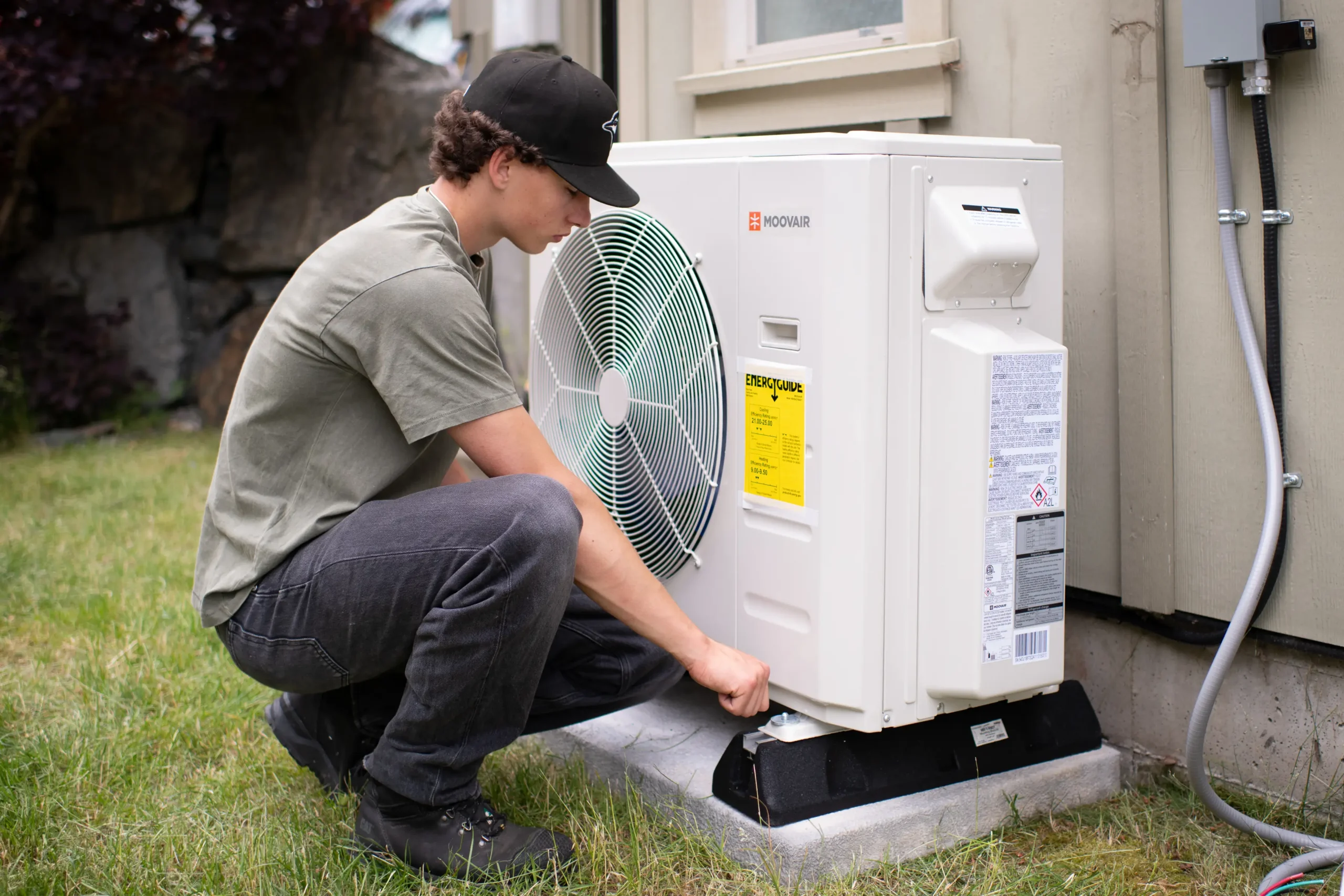 Sasquatch technician installing a Moovair heat pump on a Vancouver Island home